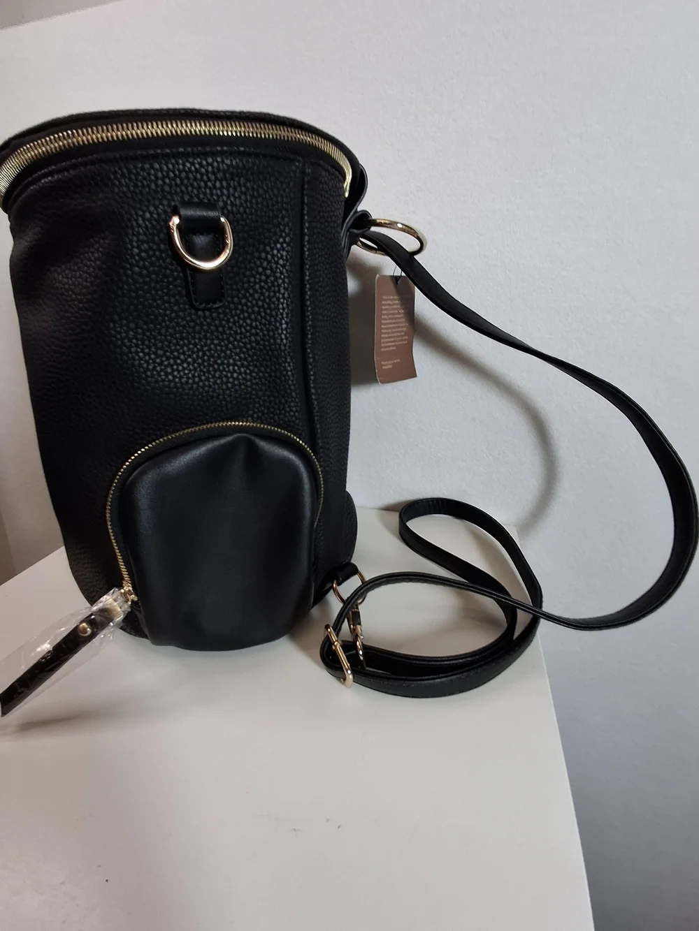SWG Black Pebbled Sling Barrel Backpack with Gold Accents
